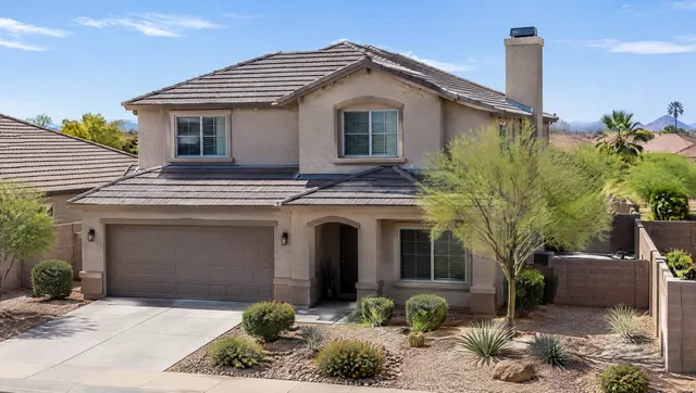 Two-story stucco home in a Chandler subdivision with a brand new roof, clean ridge and hip lines, fresh flashing at the chimney chase, desert landscaping and a block wall